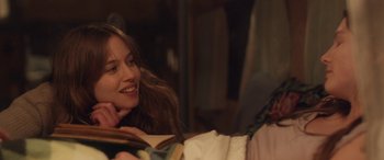 Movie still from “Breathe” (2014), directed by Mélanie Laurent – A woman sitting next to a man holding a book; Close Up shot, Over the shoulder angle