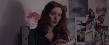 Movie still from “Breathe” (2014), directed by Mélanie Laurent – A woman with long red curly hair holding a tablet; Close Up shot, Over the shoulder angle