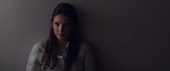 Movie still from “Breathe” (2014), directed by Mélanie Laurent – A woman in a white shirt is leaning against a wall; Close Up shot, Low angle