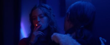 Movie still from “Breathe” (2014), directed by Mélanie Laurent – A woman smoking a cigarette in front of a mirror; Close Up shot, Over the shoulder angle