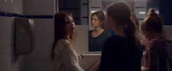 Movie still from “Breathe” (2014), directed by Mélanie Laurent – Two women in front of a mirror in a bathroom; Medium shot, Over the shoulder angle