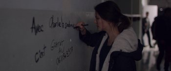 Movie still from “Breathe” (2014), directed by Mélanie Laurent – A woman writing on a wall with a marker; Close Up shot, High angle