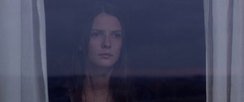Movie still from “Breathe” (2014), directed by Mélanie Laurent – A woman looking out of a window at night; Close Up shot, Low angle