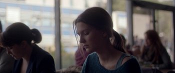 Movie still from “Breathe” (2014), directed by Mélanie Laurent – A woman sitting in front of a window with her eyes closed; Close Up shot, Over the shoulder angle