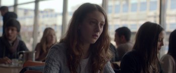 Movie still from “Breathe” (2014), directed by Mélanie Laurent – A woman with long hair is sitting in front of a group of people; Close Up shot, Over the shoulder angle