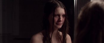 Movie still from “Breathe” (2014), directed by Mélanie Laurent – A young woman with wet hair and a bare chest; Close Up shot, High angle