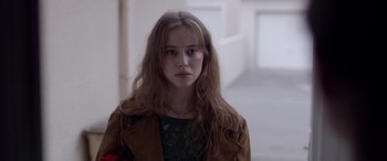 Movie still from “Breathe” (2014), directed by Mélanie Laurent – A woman with long hair and a green dress; Close Up shot, Over the shoulder angle