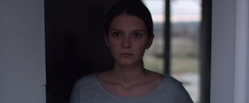 Movie still from “Breathe” (2014), directed by Mélanie Laurent – A young woman is staring into the camera; Close Up shot, Over the shoulder angle