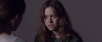Movie still from “Breathe” (2014), directed by Mélanie Laurent – A woman with long hair is looking at the camera; Close Up shot, Over the shoulder angle