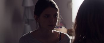Movie still from “Breathe” (2014), directed by Mélanie Laurent – A young woman is looking at the camera; Close Up shot, Over the shoulder angle