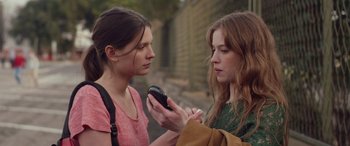 Movie still from “Breathe” (2014), directed by Mélanie Laurent – Two young women are looking at a cell phone; Close Up shot, Over the shoulder angle