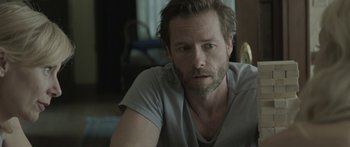 Movie still from “Breathe In” (2013), directed by Drake Doremus – A person sitting in a room; Close Up shot, Over the shoulder angle