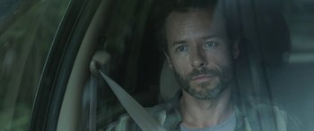 Movie still from “Breathe In” (2013), directed by Drake Doremus – A man holding a knife in a car seat; Close Up shot, Over the shoulder angle