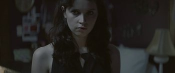 Movie still from “Breathe In” (2013), directed by Drake Doremus – A woman with long black hair stares into the camera; Close Up shot, Over the shoulder angle