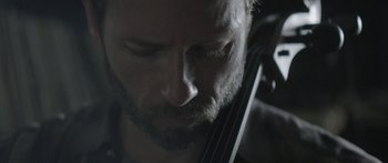 Movie still from “Breathe In” (2013), directed by Drake Doremus – A person holding a violin; Extreme Close Up shot, Over the shoulder angle