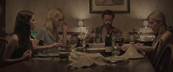 Movie still from “Breathe In” (2013), directed by Drake Doremus – A man and a woman sitting at a dinner table; Medium shot, High angle