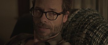 Movie still from “Breathe In” (2013), directed by Drake Doremus – A person wearing glasses; Close Up shot, Over the shoulder angle