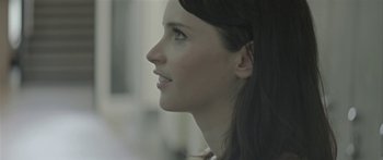 Movie still from “Breathe In” (2013), directed by Drake Doremus – A woman's face looking to the side; Close Up shot, Over the shoulder angle