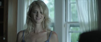 Movie still from “Breathe In” (2013), directed by Drake Doremus – A beautiful young woman with long blonde hair and blue eyes; Close Up shot, Over the shoulder angle