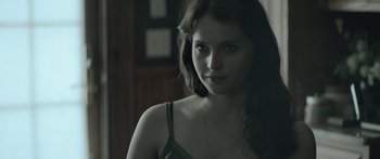 Movie still from “Breathe In” (2013), directed by Drake Doremus – A beautiful young lady with long dark brown hair; Close Up shot, Over the shoulder angle