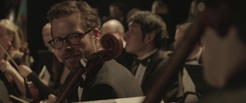 Movie still from “Breathe In” (2013), directed by Drake Doremus – A man with a beard holding a pipe in his mouth; Close Up shot, Low angle