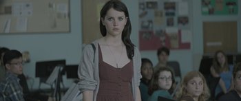 Movie still from “Breathe In” (2013), directed by Drake Doremus – A woman standing in front of a group of people; Close Up shot, Over the shoulder angle