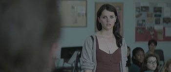 Movie still from “Breathe In” (2013), directed by Drake Doremus – A woman standing in front of a wall in a room; Close Up shot, Over the shoulder angle