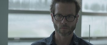 Movie still from “Breathe In” (2013), directed by Drake Doremus – A person wearing glasses; Close Up shot, Over the shoulder angle
