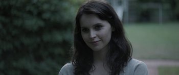 Movie still from “Breathe In” (2013), directed by Drake Doremus – A beautiful young woman with long dark hair; Close Up shot, Over the shoulder angle
