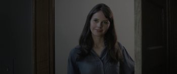 Movie still from “Breathe In” (2013), directed by Drake Doremus – A woman with long black hair standing in front of a mirror; Close Up shot, Over the shoulder angle