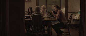 Movie still from “Breathe In” (2013), directed by Drake Doremus – A group of people sitting around a table; Medium shot, High angle