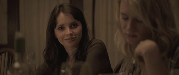 Movie still from “Breathe In” (2013), directed by Drake Doremus – A woman sitting in front of another woman in front of a mirror; Close Up shot, Over the shoulder angle