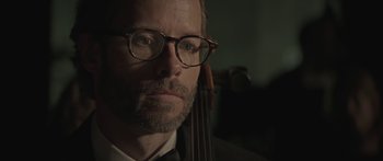 Movie still from “Breathe In” (2013), directed by Drake Doremus – A person wearing glasses and a bow tie; Close Up shot, Over the shoulder angle