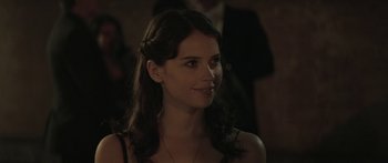 Movie still from “Breathe In” (2013), directed by Drake Doremus – A beautiful woman with long dark hair wearing a black dress; Close Up shot, Over the shoulder angle