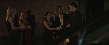 Movie still from “Breathe In” (2013), directed by Drake Doremus – A man and a woman shaking hands at a party; Medium shot, Over the shoulder angle