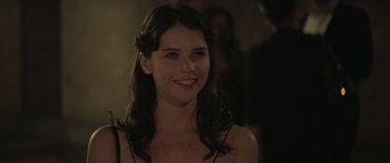 Movie still from “Breathe In” (2013), directed by Drake Doremus – A woman with long dark hair smiling for the camera; Close Up shot, Over the shoulder angle