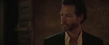 Movie still from “Breathe In” (2013), directed by Drake Doremus – A person wearing a suit and tie; Close Up shot, Over the shoulder angle