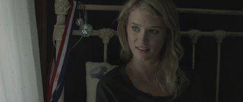 Movie still from “Breathe In” (2013), directed by Drake Doremus – A young woman is posing for a picture; Close Up shot, Over the shoulder angle