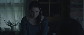 Movie still from “Breathe In” (2013), directed by Drake Doremus – A woman sitting in front of a window in a dark room; Close Up shot, Over the shoulder angle