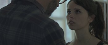 Movie still from “Breathe In” (2013), directed by Drake Doremus – A man and a woman face to face in a room; Close Up shot, Over the shoulder angle