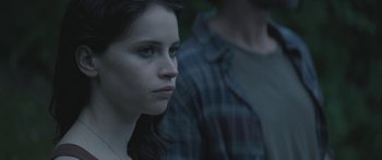 Movie still from “Breathe In” (2013), directed by Drake Doremus – A young woman sitting in front of a man; Close Up shot, Over the shoulder angle