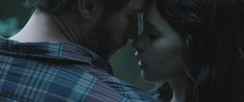 Movie still from “Breathe In” (2013), directed by Drake Doremus – A man and a woman are kissing in the dark; Close Up shot, Over the shoulder angle