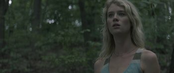 Movie still from “Breathe In” (2013), directed by Drake Doremus – A woman standing in the woods looking into the distance; Close Up shot, Low angle