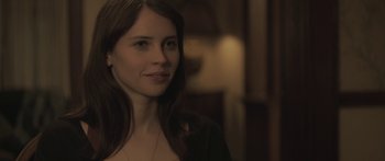 Movie still from “Breathe In” (2013), directed by Drake Doremus – A beautiful woman with long brown hair wearing a black jacket; Close Up shot, Over the shoulder angle
