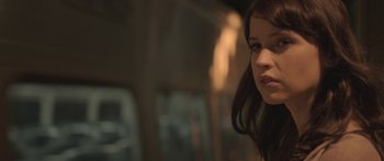 Movie still from “Breathe In” (2013), directed by Drake Doremus – A woman's face in a dark room; Close Up shot, Low angle