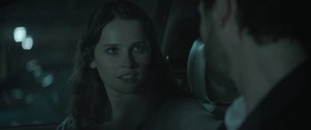 Movie still from “Breathe In” (2013), directed by Drake Doremus – A woman sitting in the back seat of a car; Close Up shot, Over the shoulder angle