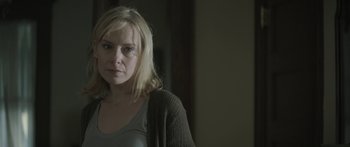 Movie still from “Breathe In” (2013), directed by Drake Doremus – A woman with blonde hair wearing a gray shirt; Close Up shot, Over the shoulder angle