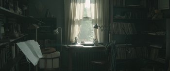 Movie still from “Breathe In” (2013), directed by Drake Doremus – A room with a desk , chair and a window; Wide shot, High angle