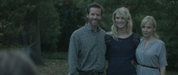 Movie still from “Breathe In” (2013), directed by Drake Doremus – A man and a woman standing next to each other in front of trees; Medium shot, Over the shoulder angle