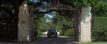 Movie still from “Brewster McCloud” (1970), directed by Robert Altman – A car driving under a wooden archway in a park; Extreme Wide shot, Low angle
